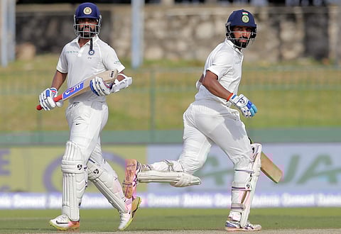 Ajinkya Rahane, left, and Cheteshwar Pujara run between the wickets during their second cricket test match. | AP