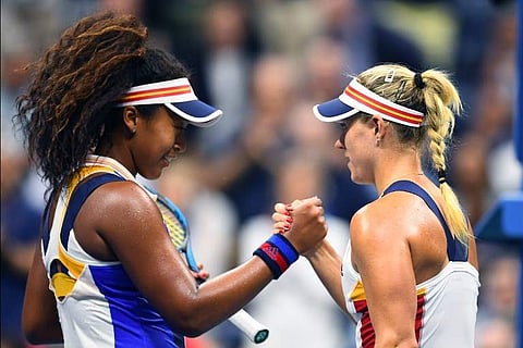Japan’s Naomi Osaka (L) shakes hands with Germany’s Angelique Kerber after winning their 2017 US Open Women's Singles match at the USTA Billie Jean King National Tennis Center in New York on August 29, 2107.|AFP