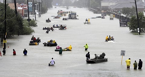 Rescue boats fill a flooded street as flood victims are evacuated as floodwaters from Tropical Storm Harvey rise. (AP)