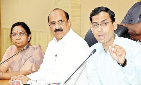 AMTZ CEO Jitendra Sharma speaking to the media at NTRUHS in Vijayawada on Tuesday. Health Minister Kamineni Srinvas is also seen | Express