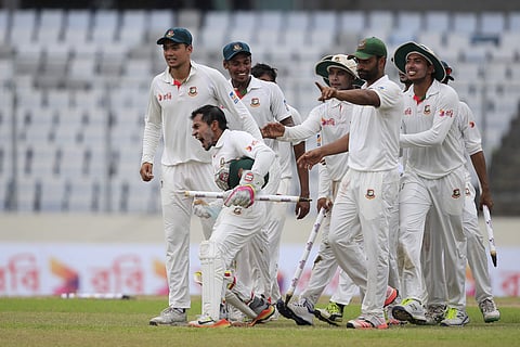 Bangladesh's cricket team captain Mushfiqur Rahim, second left, and his teammates celebrate their victory against Australia during the fourth day of their first test cricket match in Dhaka. | AP