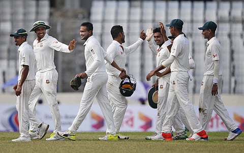Bangladesh's Shakib Al Hasan celebrates with his teammates after pulling a fifer in the first Test against Australia in Dhaka (AP)