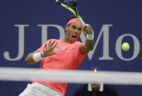 Rafael Nadal, of Spain, returns a shot from Dusan Lajovic, of Serbia, during the first round of the U.S. Open tennis tournament. | AP