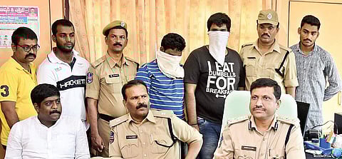 Excise officials present two NIT-Warangal students caught with LSD strips before the media in Warangal on Wednesday | EXPRESS PHOTO