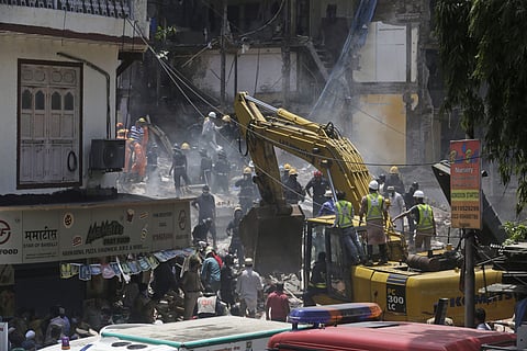 Rescue workers clear debris from the site of the building collapsed building in Mumbai. (Photo | AP)