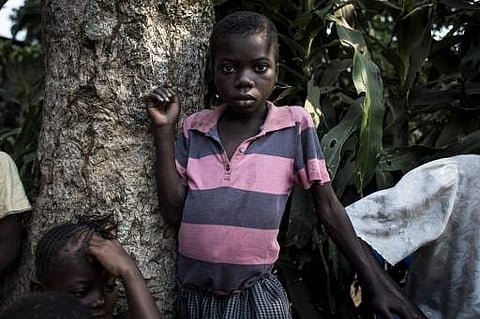 A boy waits with other Internally Displaced Persons (IDP) at a camp for IDP's fleeing from the conflict in the Kasai Province on June 4. (File Photo | AFP)