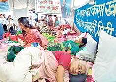 Narmada Bachao Andolan leader Medha Patkar (foreground) and others fasting for the cause of Sardar Sarovar Project-affected people in Chikilda village of Dhar district in Madhya Pradesh on Friday | Express