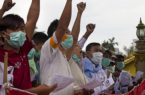 Buddhist nationalists shout slogans during a protest at their camp at entrance of a pagoda (AP)