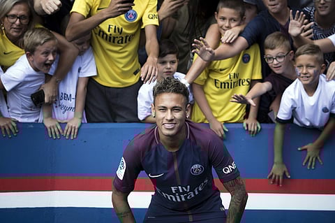 Brazilian soccer star Neymar poses for a photograph with supporters, at the Parc des Princes stadium in Paris. | AP