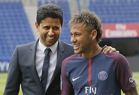 Brazilian soccer star Neymar walks away with the chairman of Paris Saint-Germain Nasser Al-Khelaifi, left, following a press conference in Paris. | AP