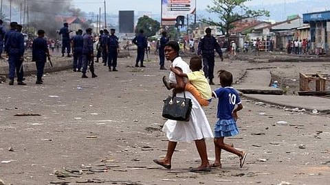 A family pass near Congolese riot police during a protest in Kinshasa, Democratic Republic of Congo, Monday, Sept. 19, 2016. (File | AP)