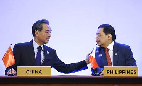 Chinese Foreign Minister Wang Yi (L) and Philippines Foreign Affairs undersecretary Manuel Teehankee during the ASEAN-China Ministerial Meeting. (AP)