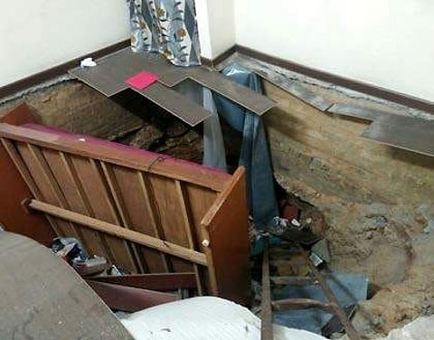 The sinkhole (above) in the bedroom of a flat in Ambattur that gave residents a scare; and the police line (left) indicating the sealing of the SSVK housing complex after officials deemed the building was unsafe for use. | Express Photo Service