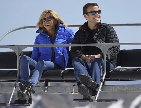 French centrist presidential election candidate Emmanuel Macron and his wife Brigitte sit on a chairlift on their way to the mountain top for a lunch break during a campaign visit in Bagneres-de-Bigorre, southwestern France. (File Photo | AP)