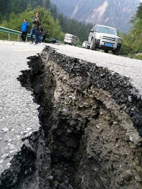 A crack, caused by an earthquake on a road is seen in picture. (AFP)