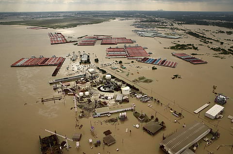 In this Aug. 30, 2017, photo, barges are secured by tugboats in the flood-swollen Burnet Bay along the Houston Ship Channel in Houston | AP