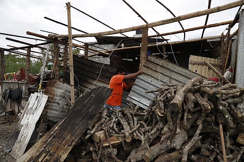 A man works on his home damaged by Hurricane Katia, in Tecolutla, Veracruz state, Mexico (AP)