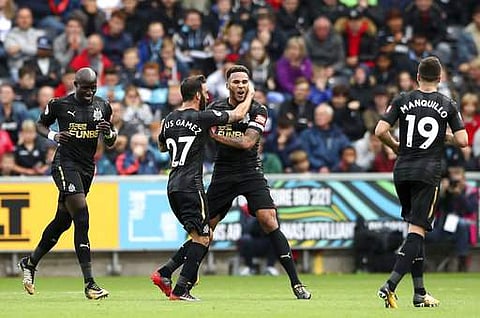 Newcastle United's Jamaal Lascelles, center right, celebrates scoring against Swansea City during the EPL match at the Liberty Stadium. | AP