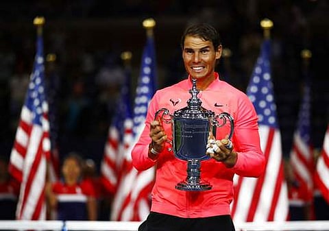 Rafael Nadal, of Spain, holds up the championship trophy after beating Kevin Anderson, of South Africa, in the men's singles final of the U.S. Open tennis tournament. | AP