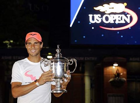 Rafael Nadal, of Spain, poses for photographers after with the championship trophy after beating Kevin Anderson, of South Africa, in the men's singles final of the U.S. Open tennis tournament. | AP