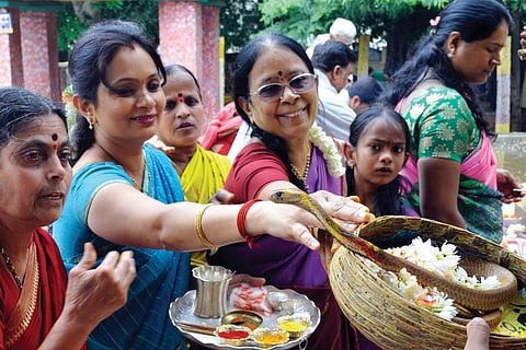 File photo of people worshipping the goddess believed to appear as a cobra. Devotees offer milk and flowers to the snake