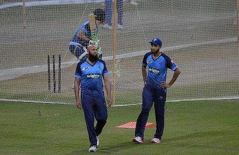 International World XI cricketers Hashim Amla (L) and Imran Tahir (R) take part in a practice session at the Gaddafi Cricket Stadium in Lahore on September 11, 2017. | AFP