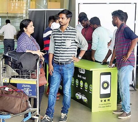 Passengers wait near the Ola kiosk at the airport on Wednesday | martin louis