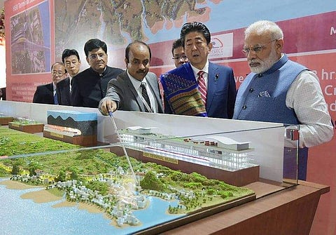 This handout photograph released by India's Press Information Bureau (PIB) on September 14, 2017 shows Indian Prime Minister Narendra Modi (L) and Japanese Prime Minister Shinzo Abe looking at a railway station model at a ground breaking ceremony for the
