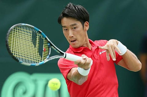 Yuichi Sugita of Japan returns the ball to Guilherme Clezar of Brazil during the first tennis match of Davis Cup World Group playoff in Osaka on September 15, 2017.|AFP