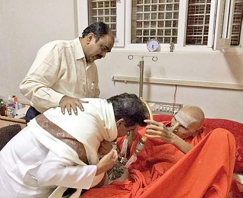 Shivakumara Swamiji blessing Water Resources Minister M B Patil at Siddaganga Mutt in Tumakuru on Thursday night. Former IPS officer Shankar Bidari looks on