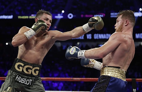Gennady Golovkin, left, fights Canelo Alvarez during a middleweight title fight Saturday, Sept. 16, 2017, in Las Vegas. | AP