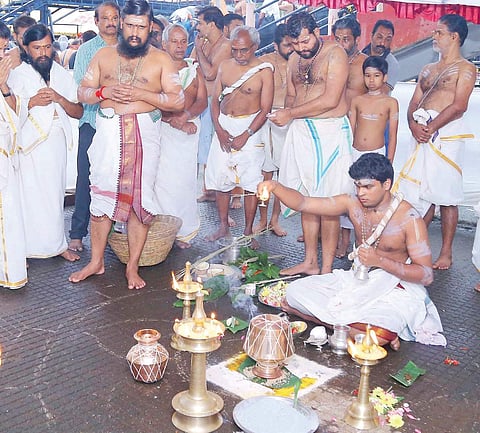 Thantri Mahesh Mohanaru performing ‘Brahmakalsa’ pooja as part of Laksharchana at the Sabarimala temple on Sunday, the first day of the Malayalam month of Kanni | Express