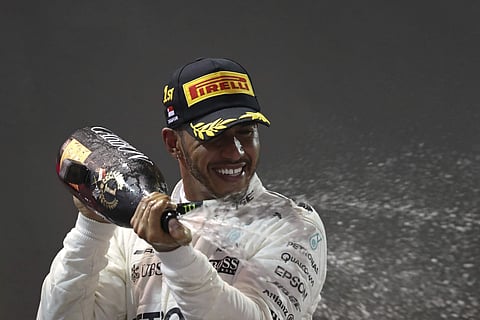 Mercedes driver Lewis Hamilton of Britain celebrates after winning the Singapore Formula One Grand Prix on the Marina Bay City Circuit Singapore, Sunday, Sept. 17, 2017. | AP
