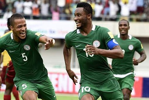 Nigeria's Mikel John Obi (C) celebrates with teammates William Ekong (L) and Odion Ighalo after scoring against Cameroon (AFP)