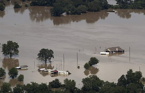 Homes are surrounded by water from the flooded Colorado River in the aftermath of Hurricane Harvey Friday, Sept. 1, 2017, near Wharton, Texas. (AP)