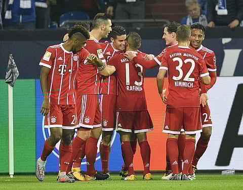 Bayern's James Rodriguez is celebrated by his team after scoring his side's second goal during the German Bundesliga soccer match between FC Schalke 04 and Bayern Munich at the Arena in Gelsenkirchen. | AP