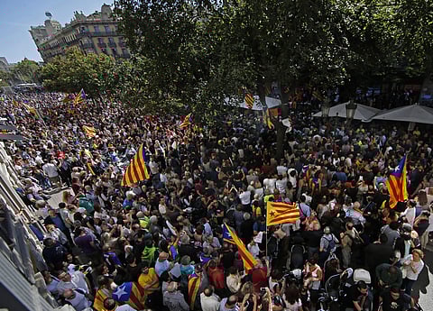 A crowd of pro-independence protestors gather outside the headquarters of the region's department of economic affairs in Barcelona.(Photo | AP)