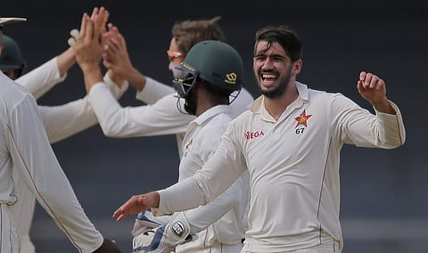 Zimbabwe's captain Graeme Cremer, right, celebrates the dismissal of Sri Lanka's Upul Tharanga (AP)