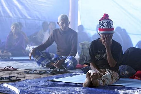Villagers sit in a temporary shelter in Bali, Indonesia, on September 23. Indonesian authorities raised the alert level for the Mount Agung volcano on the tourist island to the highest level. (Photo | AP)