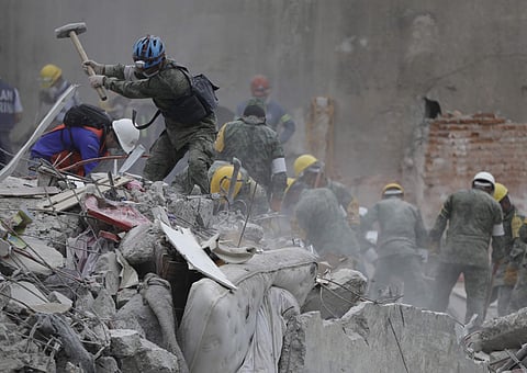 Rescue workers search for survivors at an apartment building that collapsed during an earthquake in the Condesa neighborhood of Mexico City on Sept. 21, 2017. (Photo | AP)
