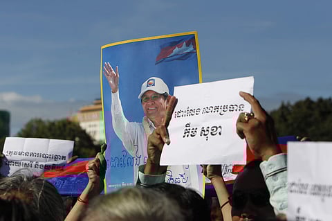 Supporters of the opposition Cambodia National Rescue Party hold up a portrait of the party leader Kem Sokha and slogans that read: 'Free Kem Sokha' during a rally near an appeals court in Phnom Penh, Cambodia on Sept. 26, 2017. (Photo | AP)