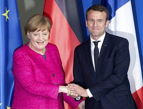 French President Emmanuel Macron, right, and German Chancellor Angela Merkel | AP