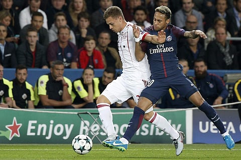 Bayern's Joshua Kimmich, left, and PSG's Neymar challenge for the ball during the Champions League soccer match between Paris Saint Germain and Bayern Munich in Paris. (AP)