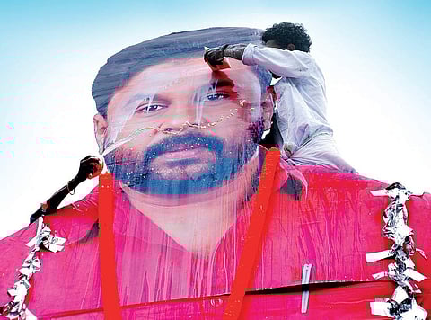 A fan pours milk on a giant cutout of actor Dileep after the first show of Ramaleela at a theatre in Kochi | K Shijith
