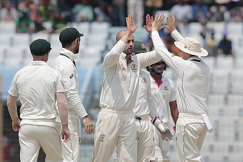 Australia's Nathan Lyon, center, celebrates with his teammates after the dismissal of Bangladesh's Mominul Haque during the first day of their second test cricket match in Chittagong. | AP