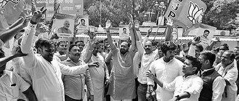 BJP activists led by State president Basant Panda celebrating after Union Minister Dharmendra Pradhan’s promotion to Cabinet rank | Express