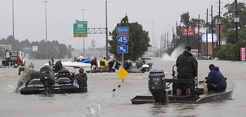 FILE - Volunteer rescue boats make their way into a flooded subdivision to rescue stranded residents as floodwaters from Tropical Storm Harvey rise Monday, Aug. 28, 2017, in Spring, Texas. | AP