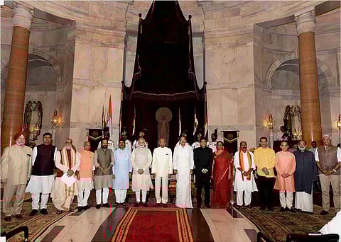 President Ram Nath Kovind, Vice President M Venkaiah Naidu, and Prime Minister Narendra Modi pose with new members of cabinet after the reshuffle at Rashtrapati Bhavan in New Delhi on Sunday. | PTI