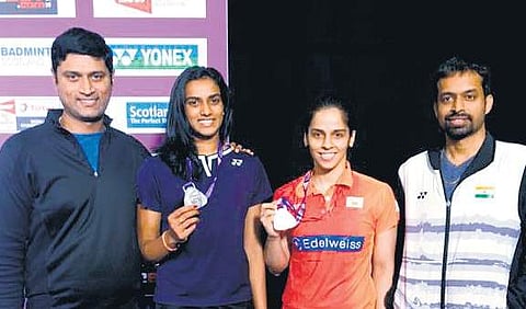 Saina Nehwal (2nd R) and Pullela Gopichand (R) during the World Championships