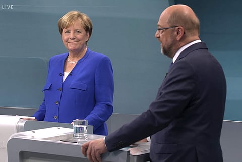 The photo provided by RTL shows German Chancellor Angela Merkel, left, of the Christian Democratic party, and her challenger Martin Schulz of the Social Democratic party attend the only TV debate three weeks before the German parliament elections in a TV